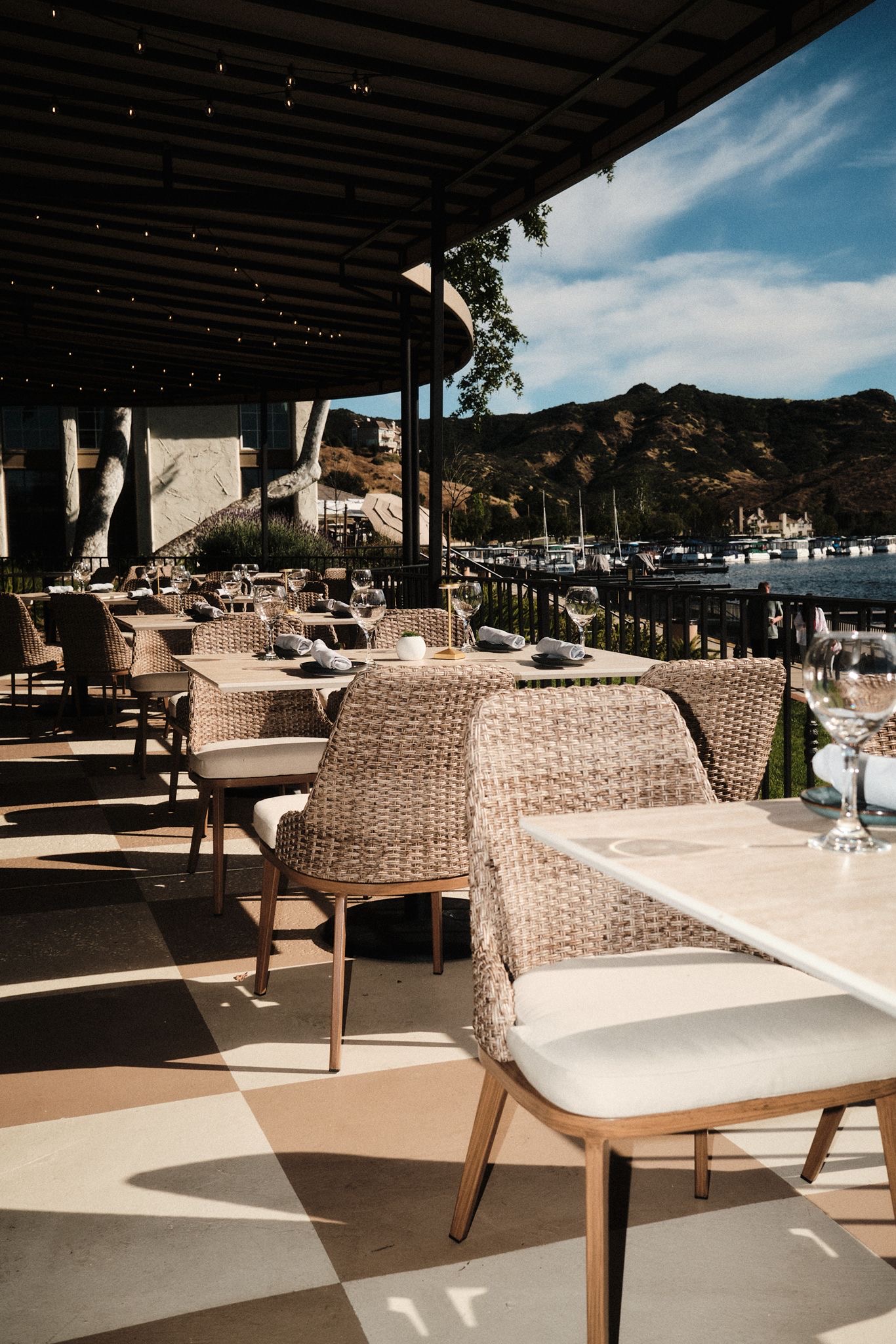 Elegant outdoor dining area at Yār on the Lake with lake and mountain views