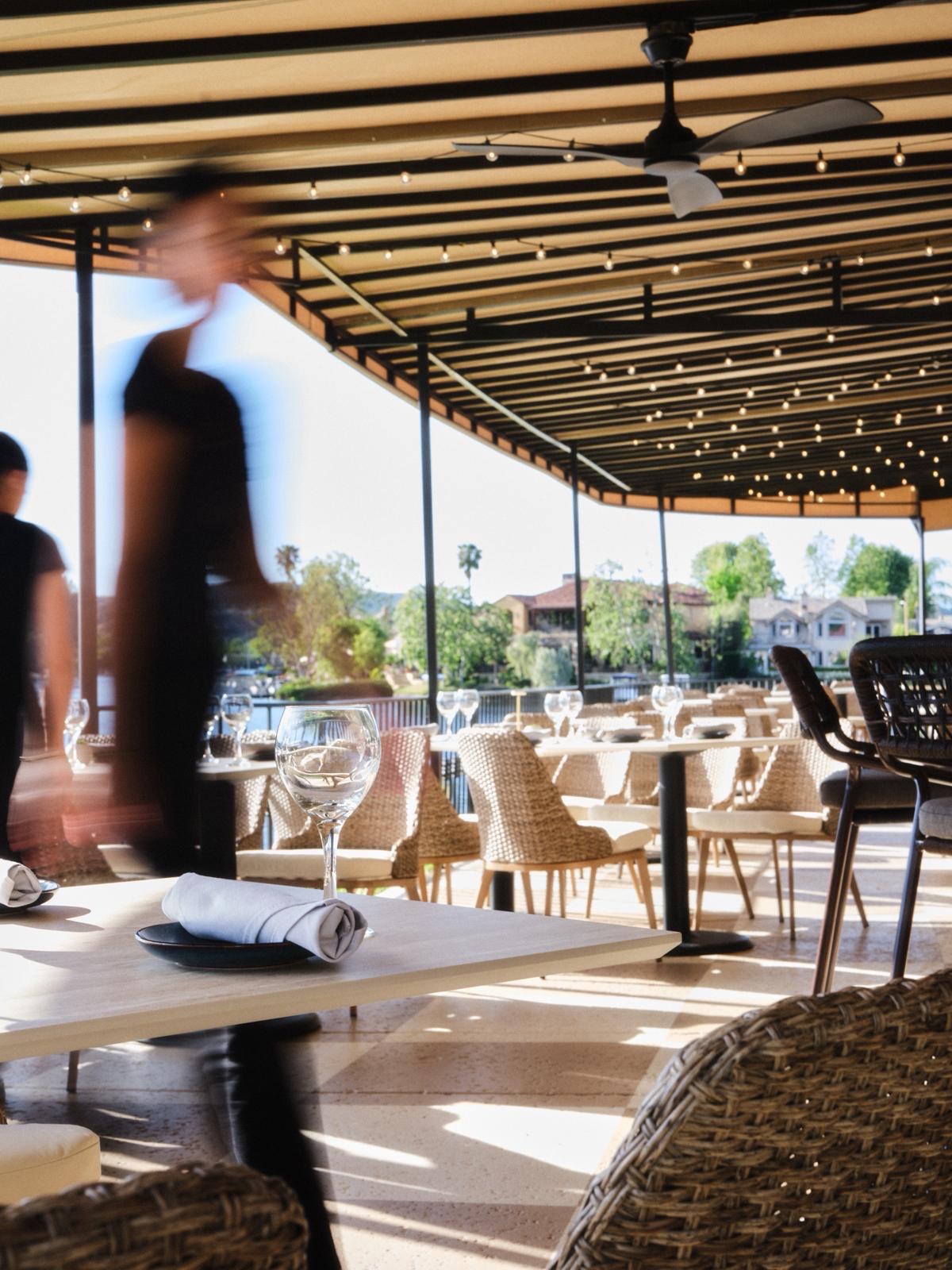 Outdoor patio dining at Yār on the Lake with lakeside views and ambiance lighting