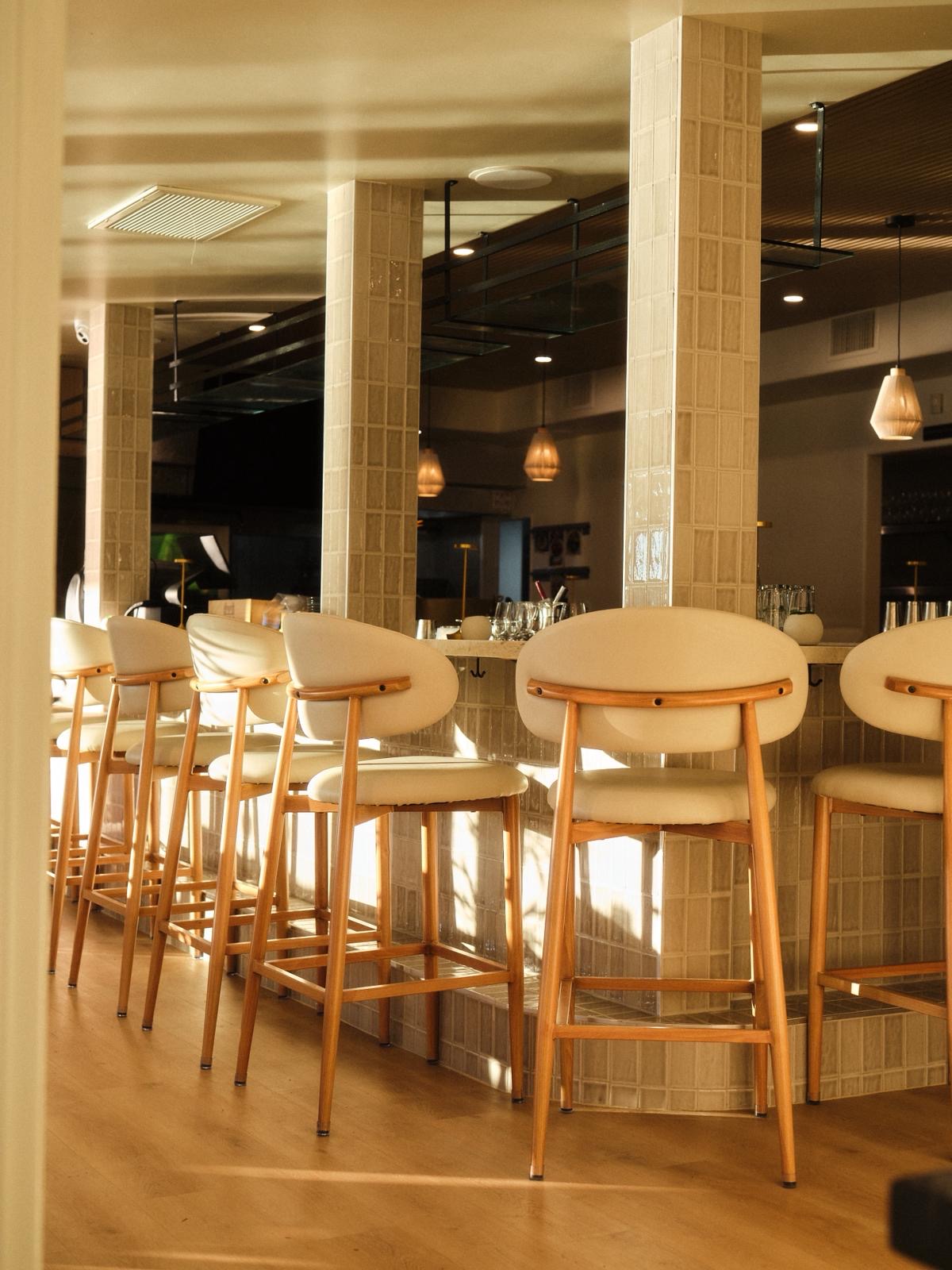 Modern bar seating at Yār on the Lake with warm Mediterranean-inspired interior